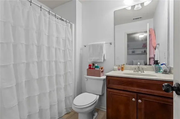 a bathroom with a sink vanity mirror and toilet