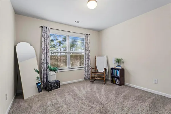 a view of a livingroom with furniture and a large window