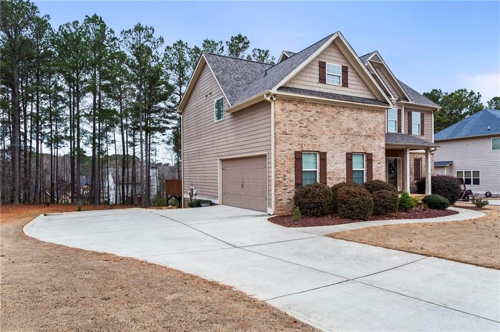 156 Starry Night Way Dallas, GA 30132 - Photo 2 of 28 a front view of a house with a yard