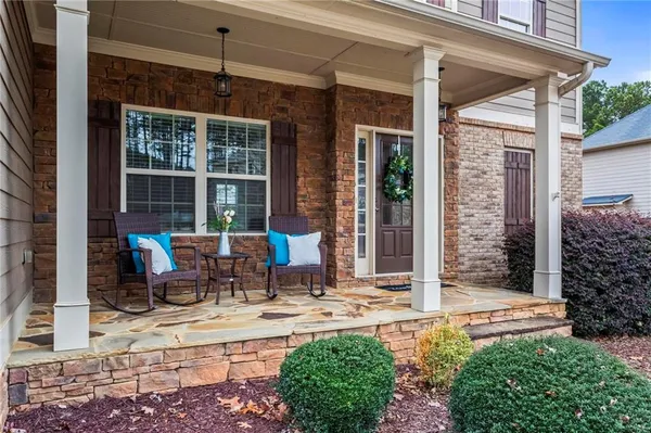 a view of backyard with outdoor seating and potted plants