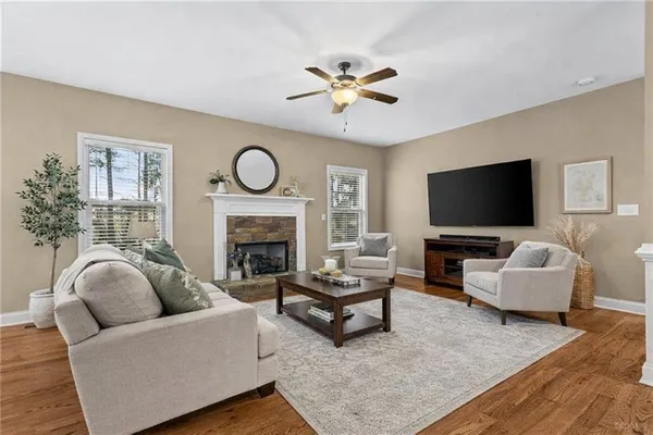 a living room with furniture flat screen tv and a fireplace