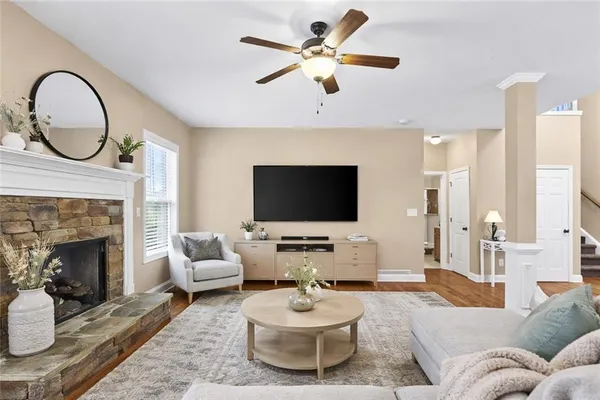 a living room with furniture a fireplace and a flat screen tv