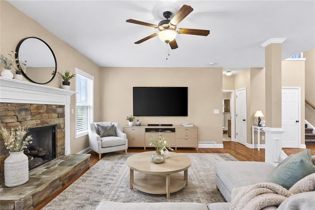 156 Starry Night Way Dallas, GA 30132 - Photo 6 of 28 a living room with furniture a fireplace and a flat screen tv