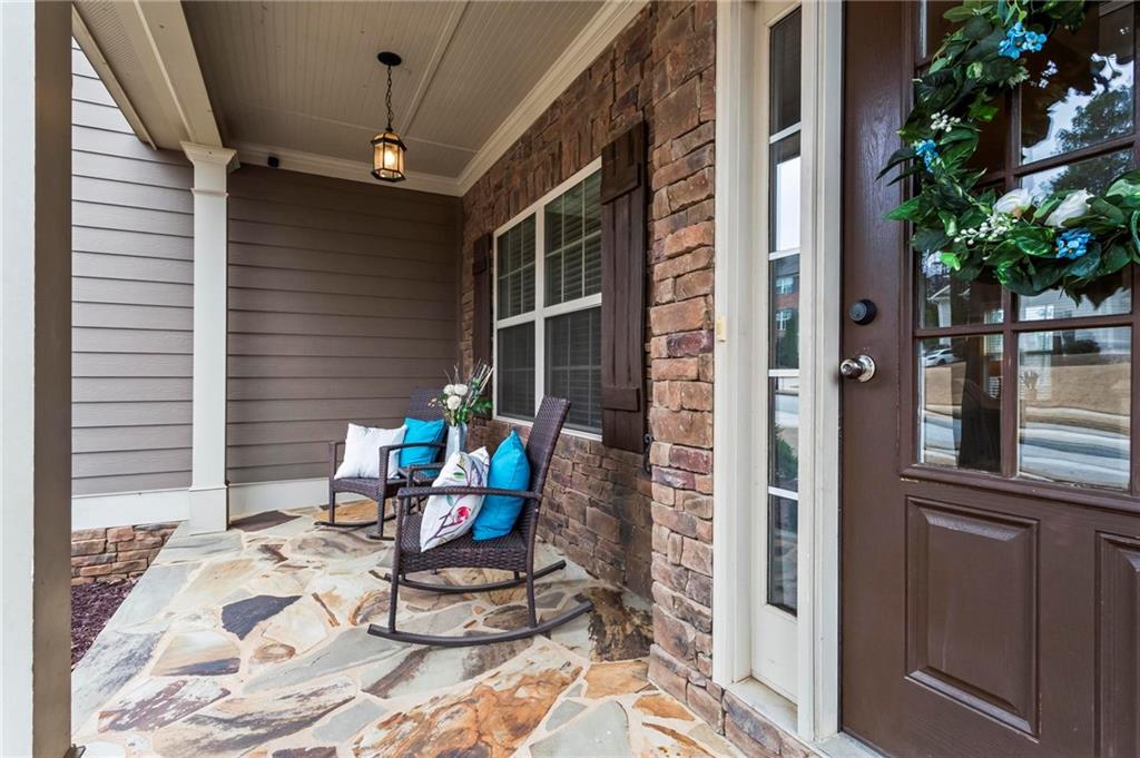 156 Starry Night Way Dallas, GA 30132 - Photo 7 of 28 a view of a balcony with chairs and potted plants