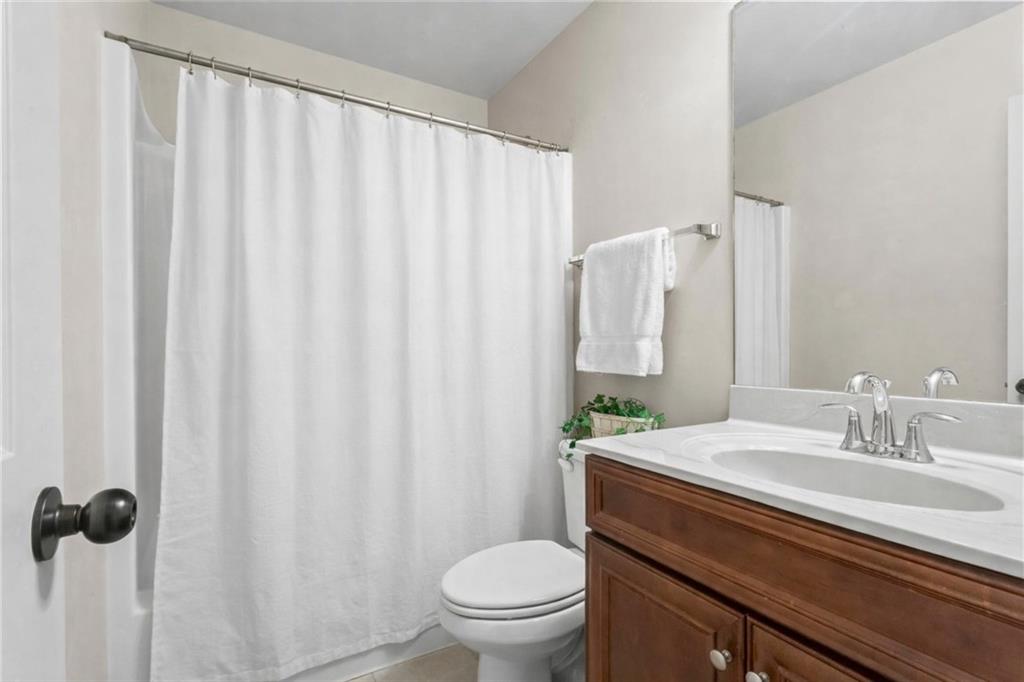 156 Starry Night Way Dallas, GA 30132 - Photo 8 of 28 a bathroom with a granite countertop sink a toilet and a mirror