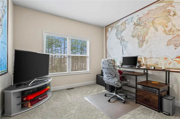 a view of a livingroom with workspace and a window
