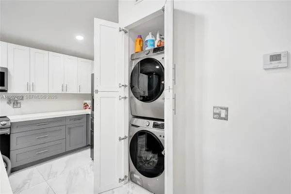a utility room with sink dryer and washer