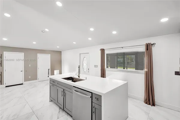 a kitchen with a sink stainless steel appliances and cabinets