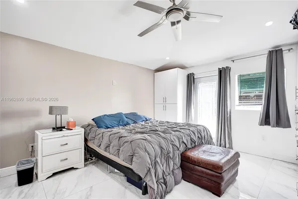 a bedroom with a bed couch and window