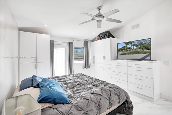 a bedroom with a large bed and a flat screen tv