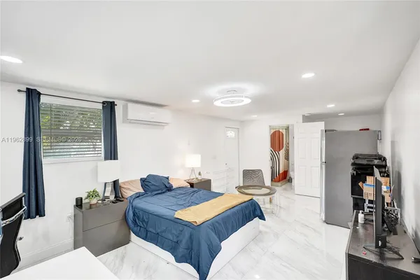 a living room with furniture a wooden floor and sink