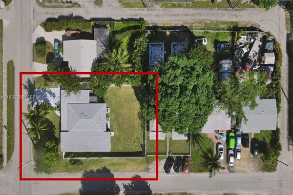 an aerial view of a houses with street