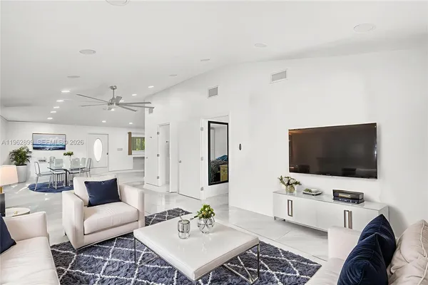 a living room with furniture and a flat screen tv