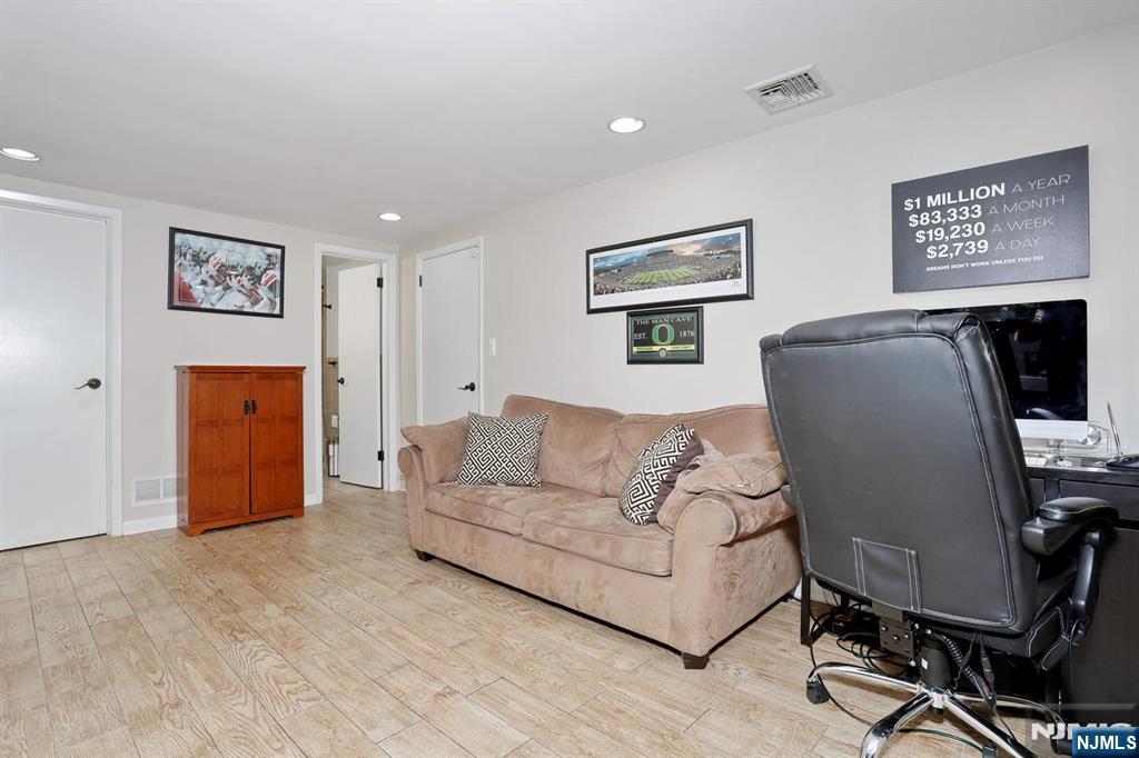 30 Brookfield Road Dumont, NJ 07628 - Photo 25 of 50 a living room with furniture and a flat screen tv
