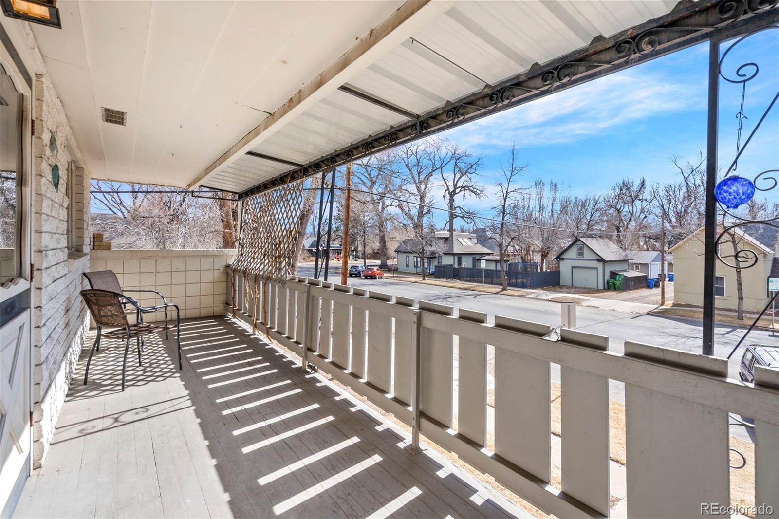 200 East Myrtle Street, Unit 8 Fort Collins, CO 80524 - Photo 18 of 21 a view of a porch with wooden floor and fence