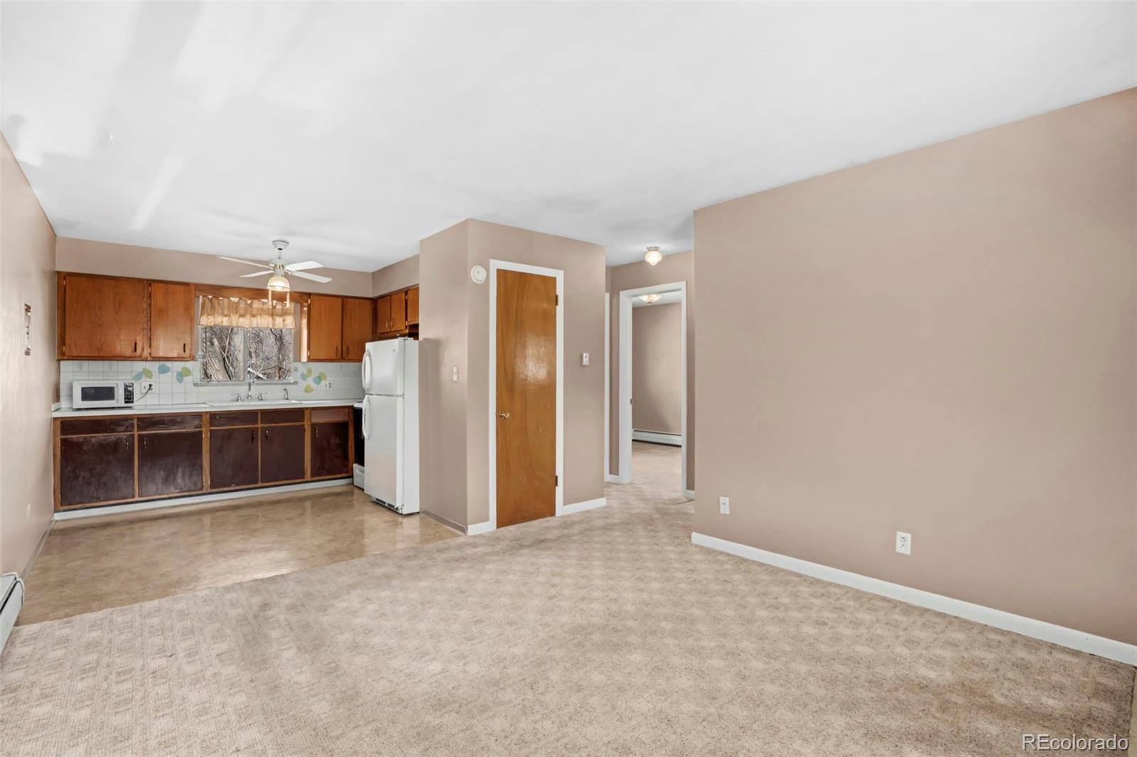 200 East Myrtle Street, Unit 8 Fort Collins, CO 80524 - Photo 2 of 21 a view of kitchen with refrigerator and window