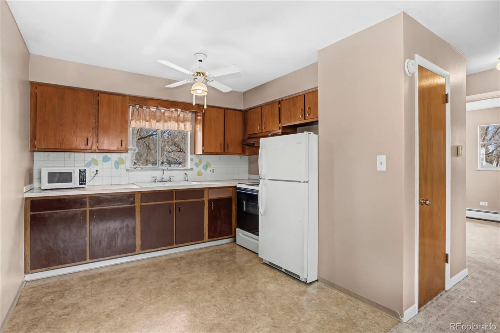 200 East Myrtle Street, Unit 8 Fort Collins, CO 80524 - Photo 4 of 21 a kitchen with kitchen island granite countertop appliances cabinets and a sink
