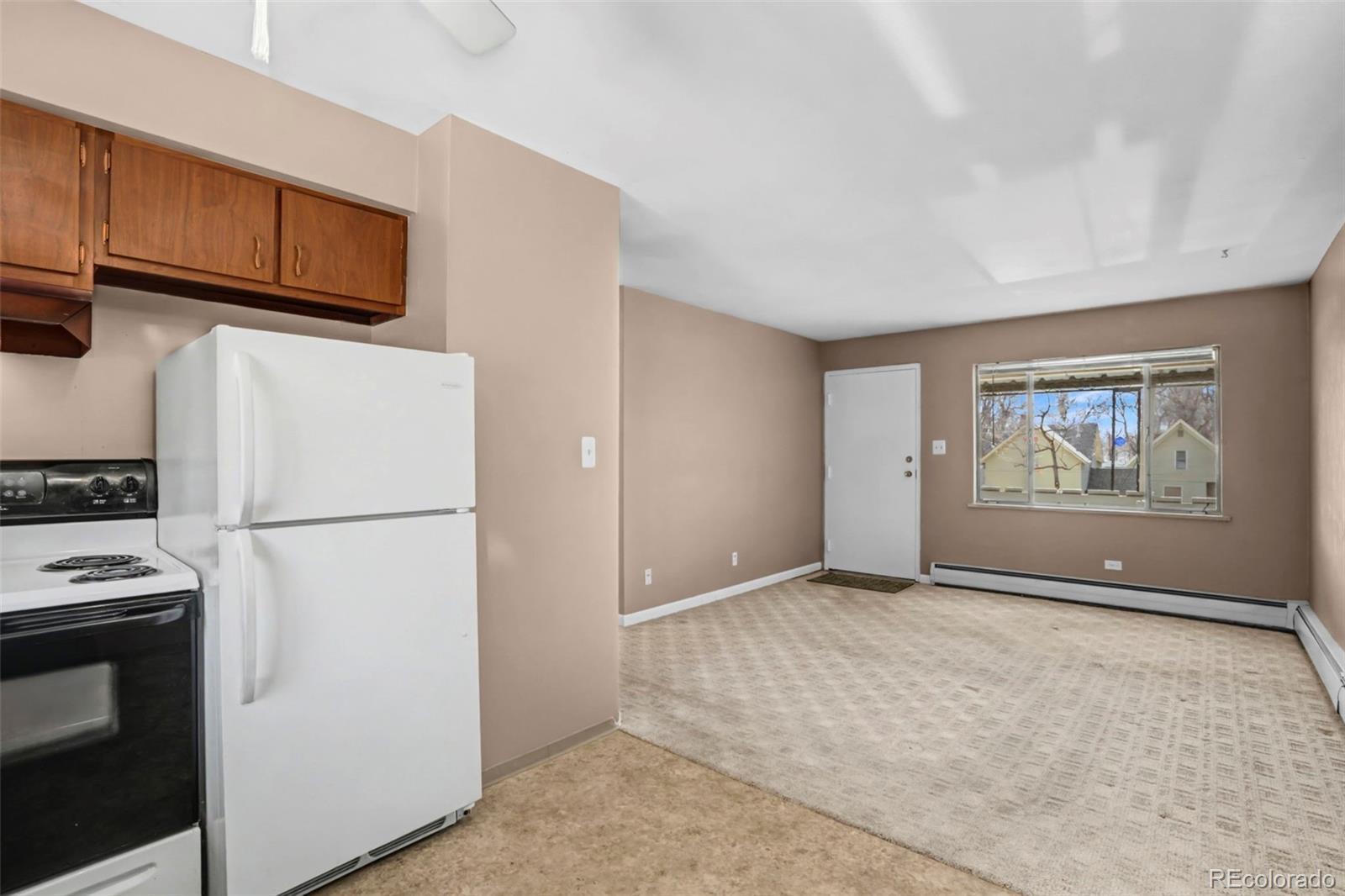 200 East Myrtle Street, Unit 8 Fort Collins, CO 80524 - Photo 6 of 21 a view of utility room with refrigerator and microwave