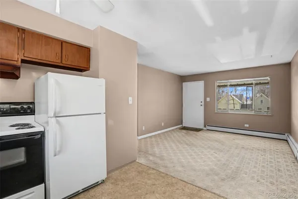 a view of utility room with refrigerator and microwave