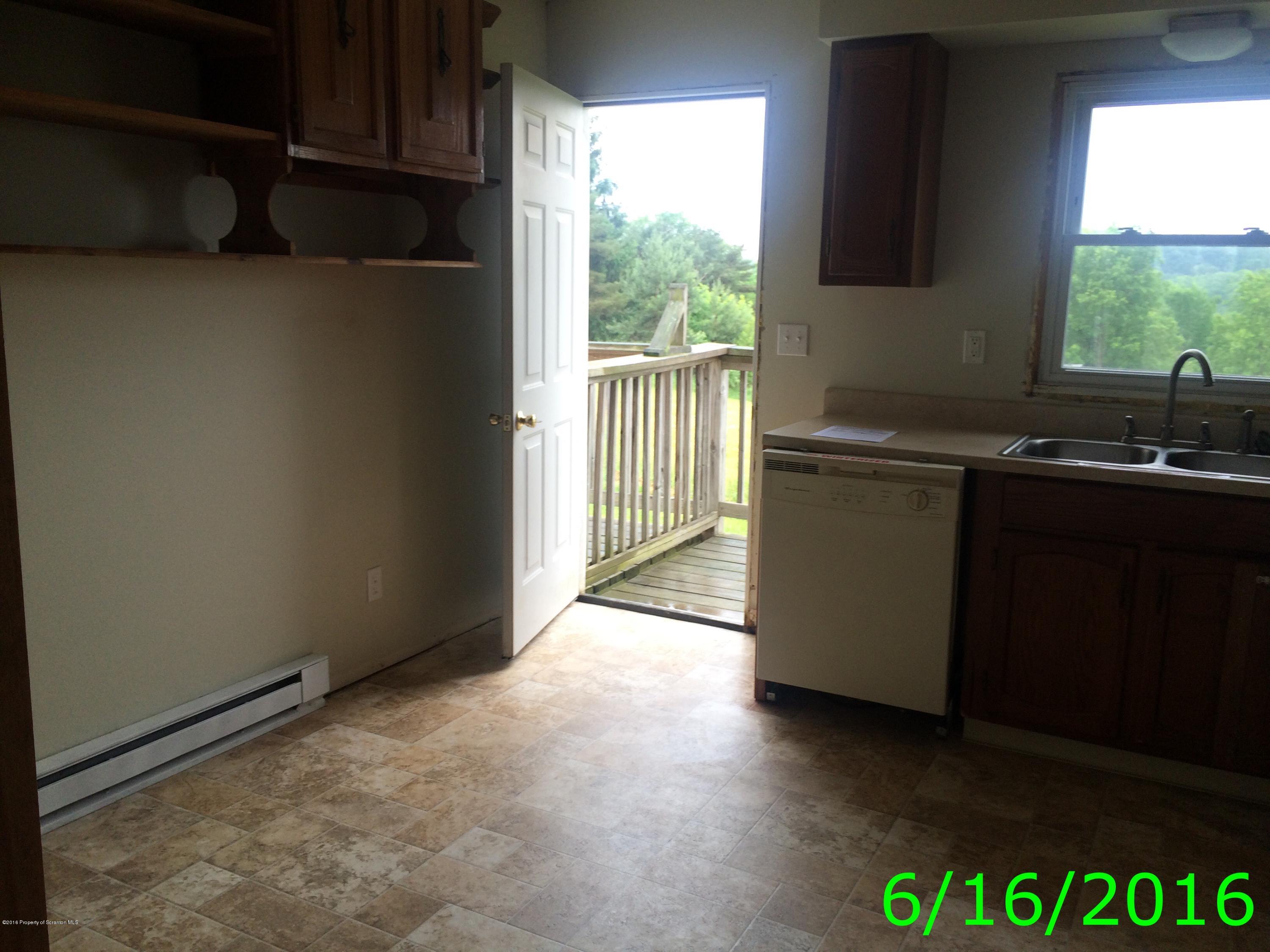 297 J&j Road Moscow, PA 18444 - Photo 7 of 25 a view of a kitchen with a sink and a window