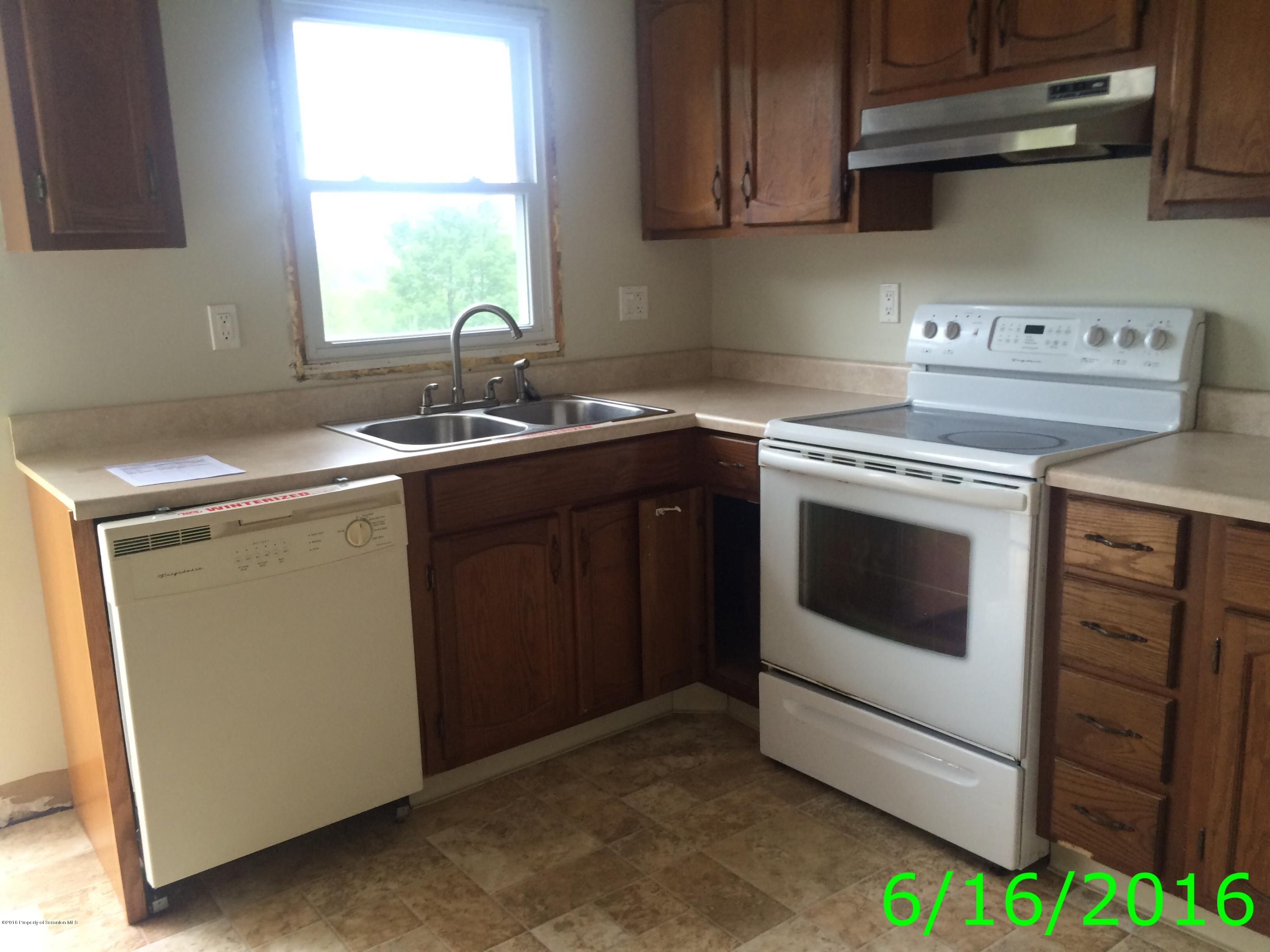 297 J&j Road Moscow, PA 18444 - Photo 8 of 25 a kitchen with a stove sink and window