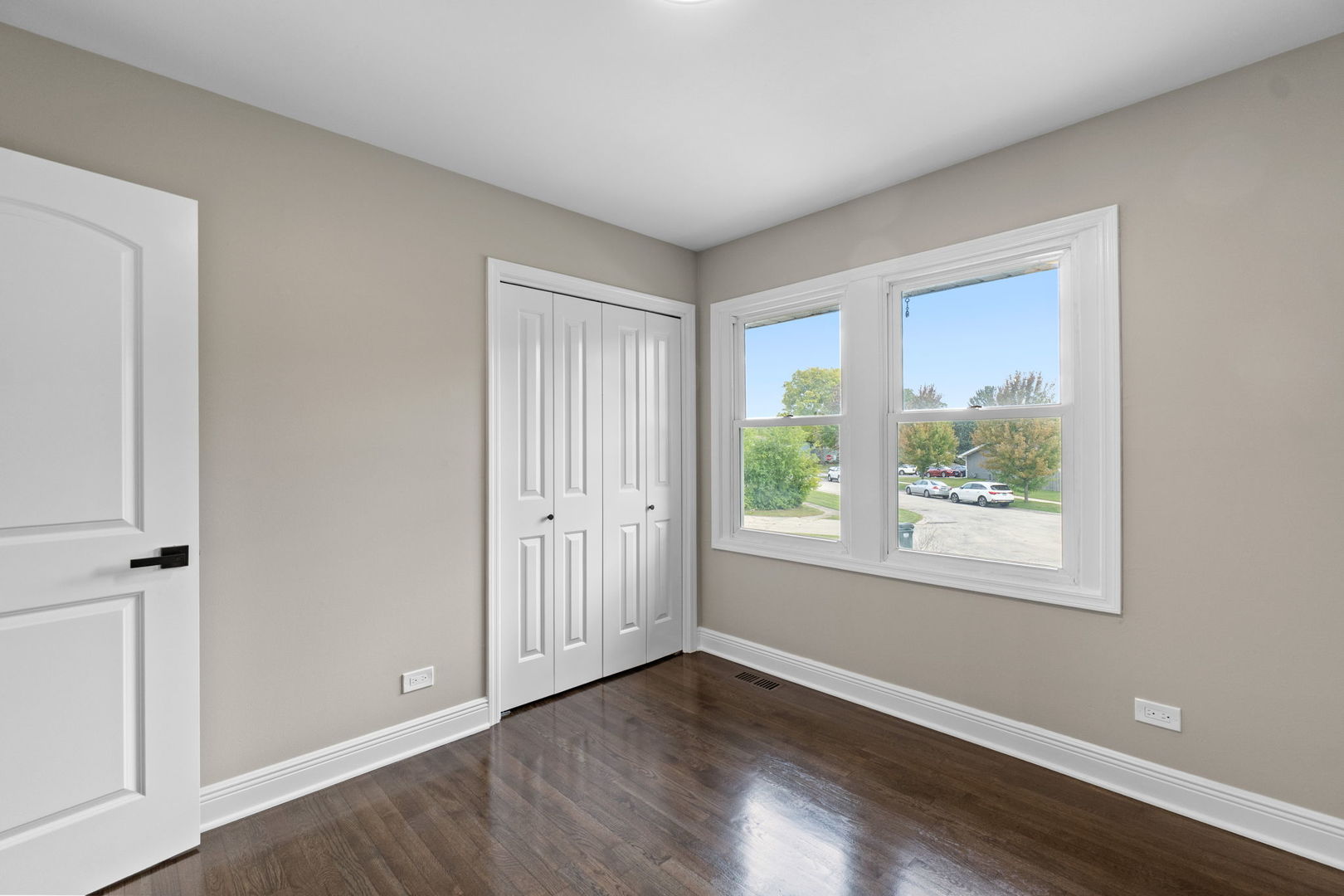 1180 Cobble Hill Court Hoffman Estates, IL 60169 - Photo 13 of 34 a view of an empty room with wooden floor and a window