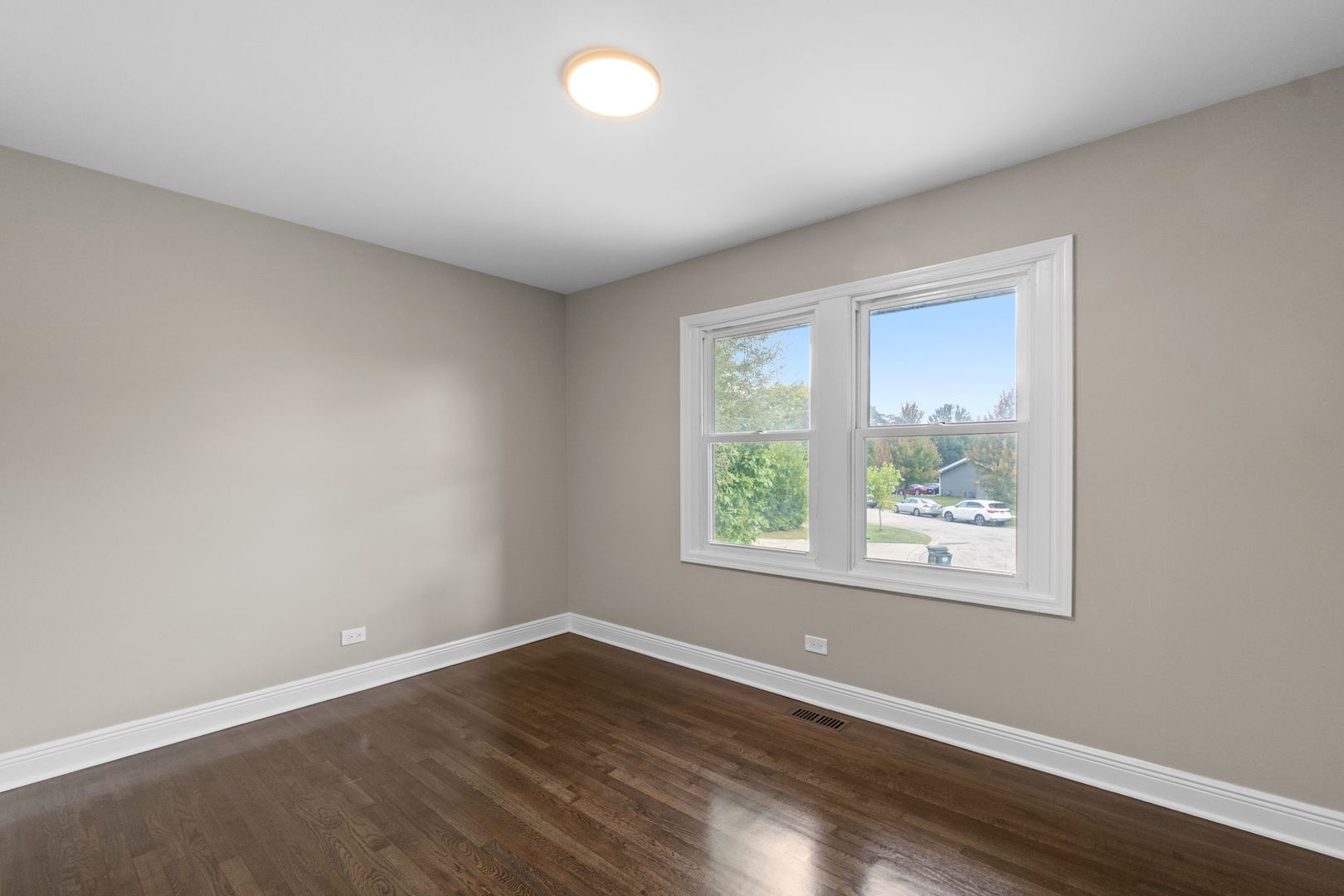 1180 Cobble Hill Court Hoffman Estates, IL 60169 - Photo 15 of 34 an empty room with wooden floor and windows