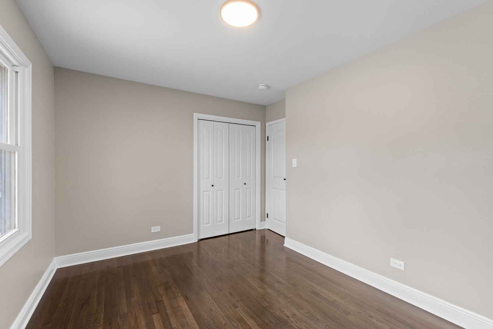 1180 Cobble Hill Court Hoffman Estates, IL 60169 - Photo 16 of 34 a view of an empty room with wooden floor and a window