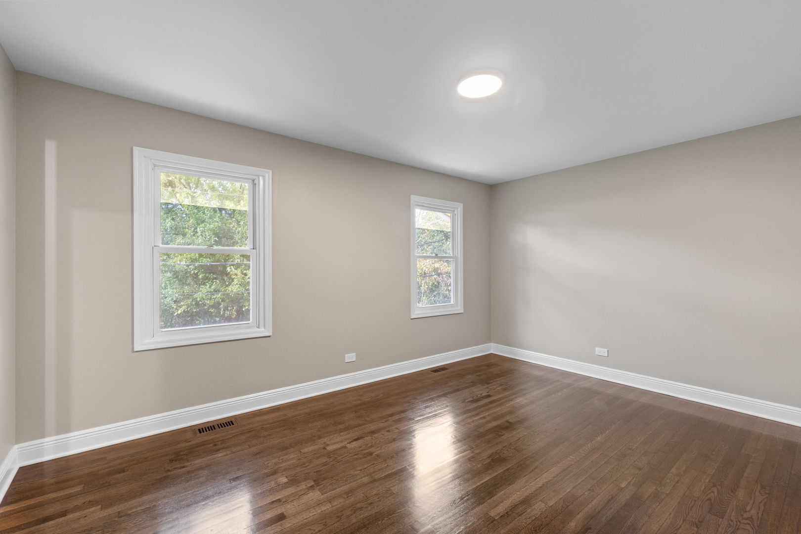 1180 Cobble Hill Court Hoffman Estates, IL 60169 - Photo 19 of 34 a view of an empty room with wooden floor and a window