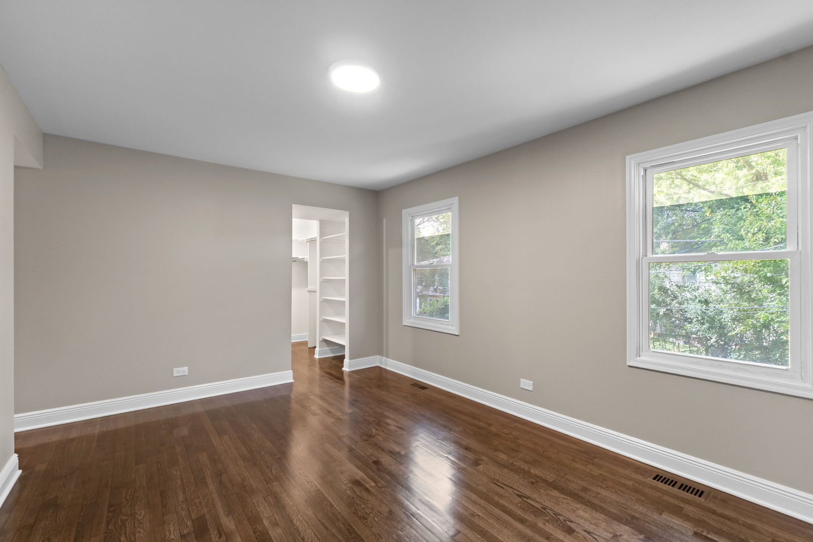 1180 Cobble Hill Court Hoffman Estates, IL 60169 - Photo 20 of 34 an empty room with wooden floor and windows
