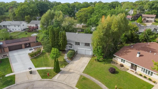 an aerial view of a house with a yard