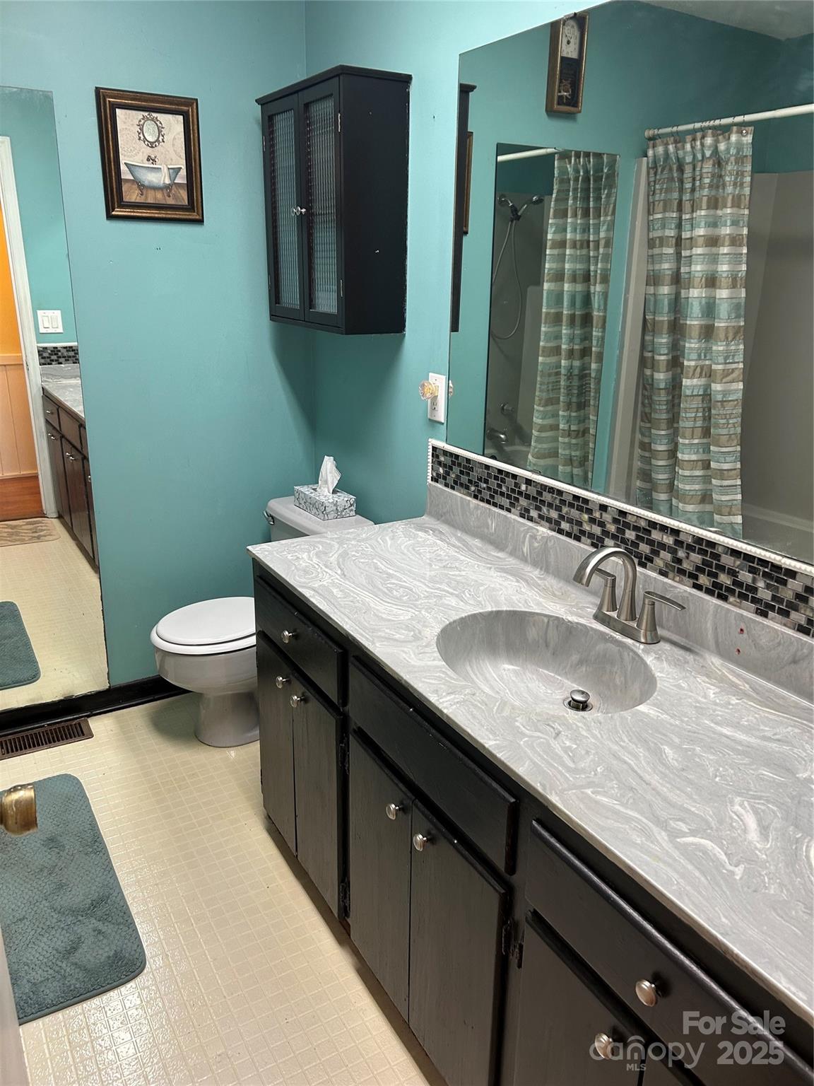 124 Blue Ridge Drive Rutherfordton, NC 28139 - Photo 33 of 48 a bathroom with a granite countertop sink a large mirror and a toilet