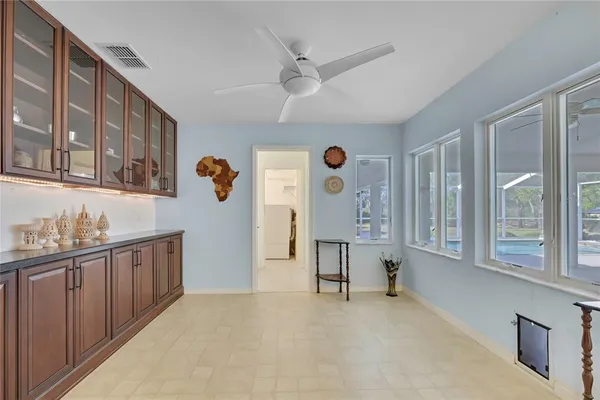 a bedroom with a bed and a flat tv screen on dresser
