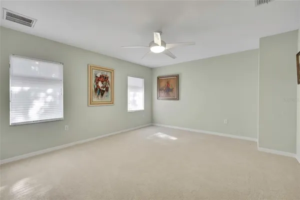 a view of an empty room with a fan