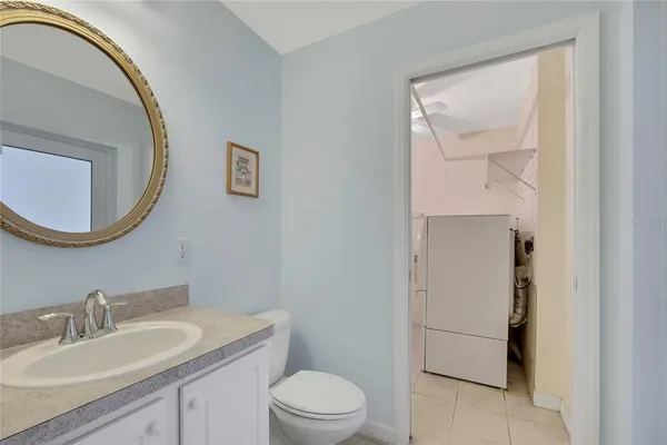a kitchen with stainless steel appliances a sink a refrigerator and cabinets