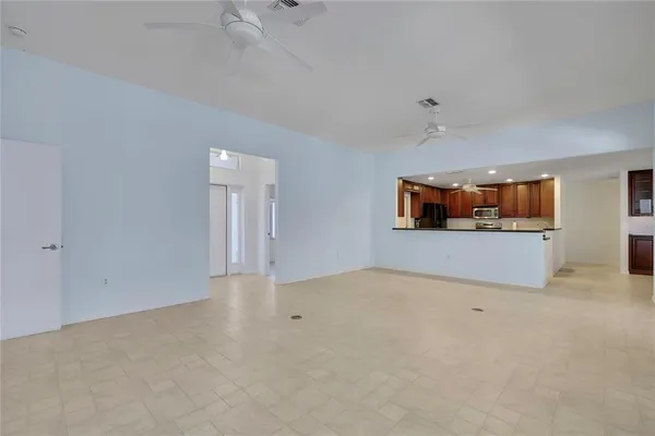 an empty room with a kitchen and a stove top oven