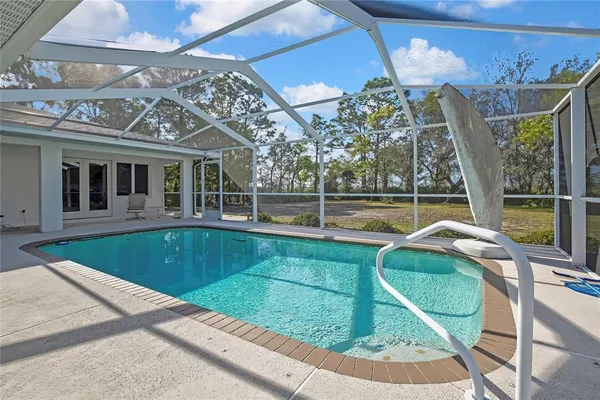 a view of a swimming pool with a lounge chairs