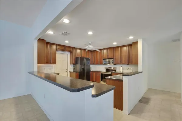 a kitchen with stainless steel appliances granite countertop a sink stove and cabinets