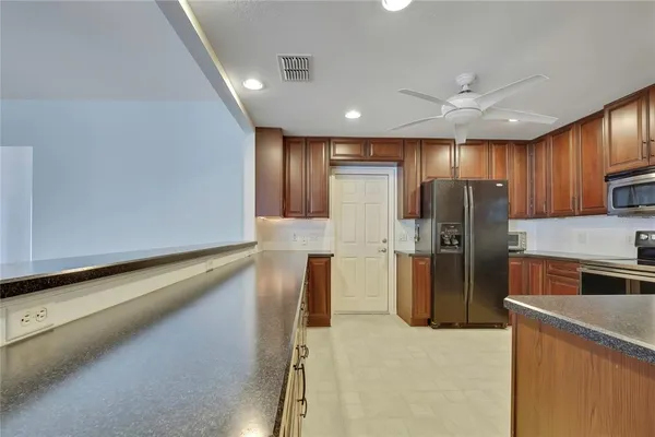 a kitchen with stainless steel appliances a refrigerator and a stove top oven