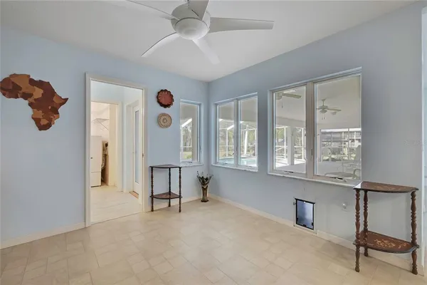 a view of a hallway with windows cabinet and stairs