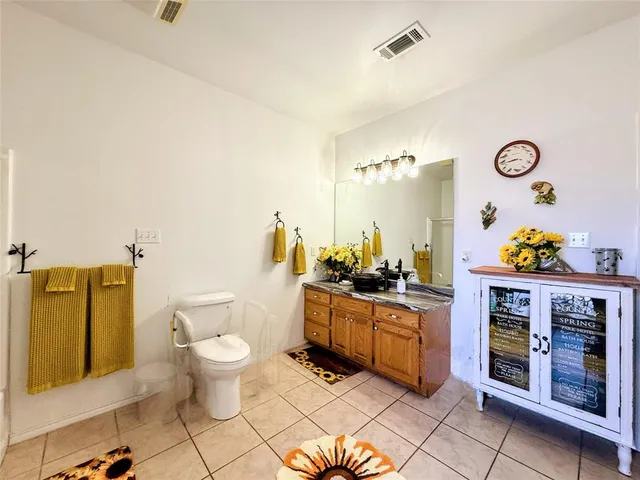 a kitchen with stainless steel appliances a stove a chimney and a center island