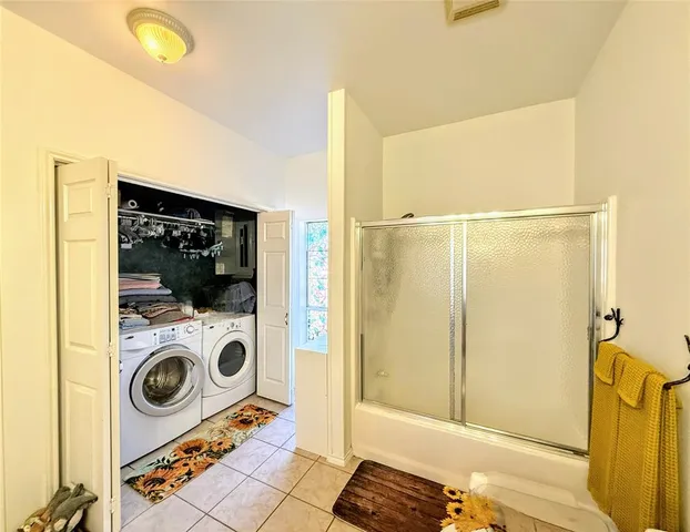 a view of a bedroom with washer and dryer