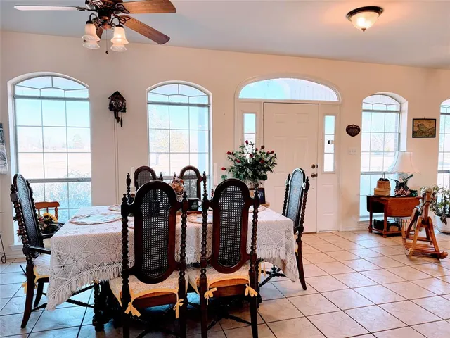 a view of a dining room with furniture and chandelier
