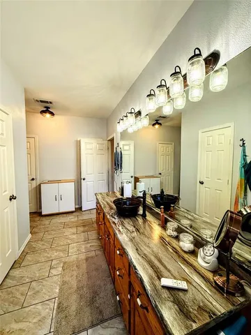 a view of a bathroom with a sink and mirror