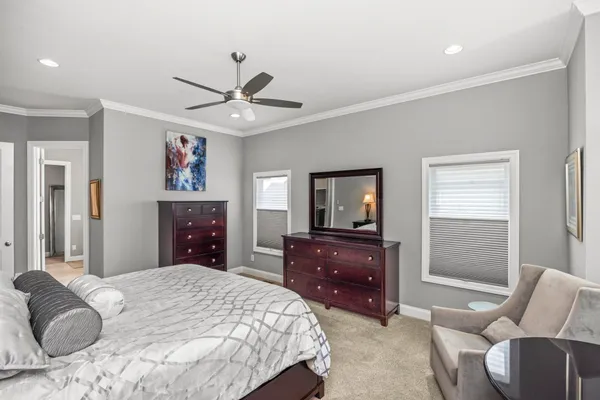 a bedroom with a bed and dresser with mirror