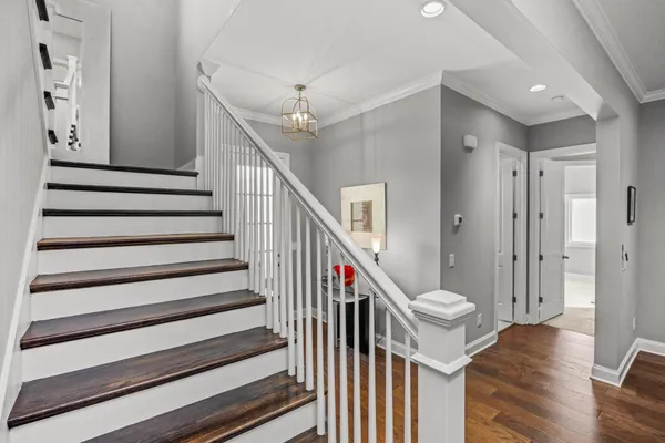 a view of entryway and hall with wooden floor