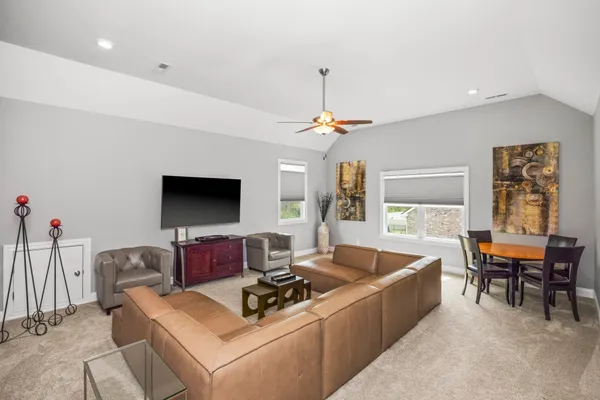 a living room with furniture and flat screen tv