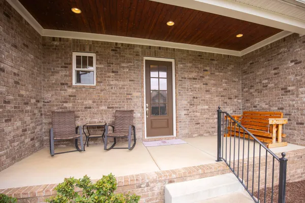 a balcony with table and chairs