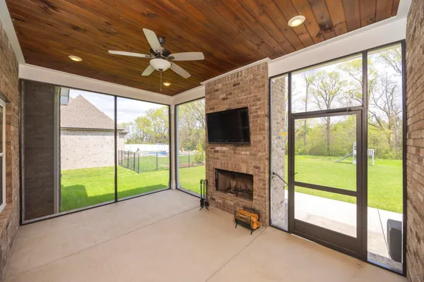 a view of an empty room with a fireplace and a large window