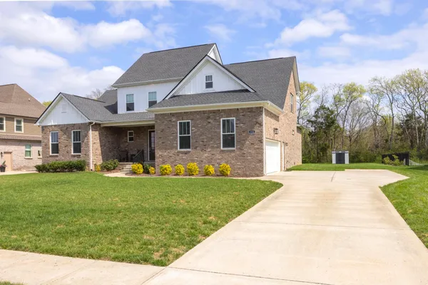 a front view of a house with a yard and garage